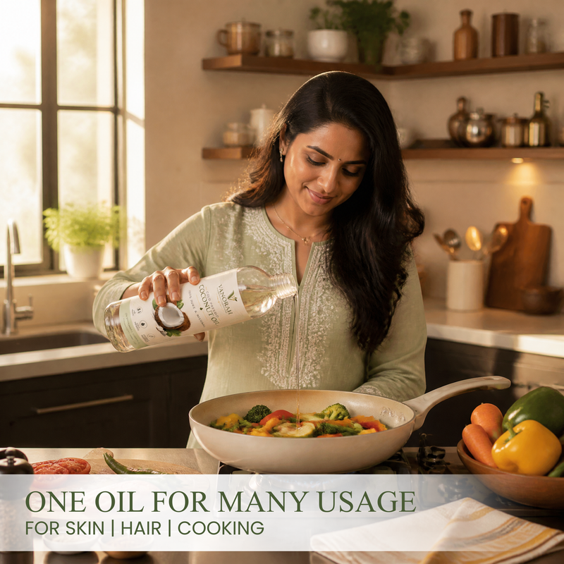 A woman in a light green embroidered top stands in a warm, sunlit kitchen, pouring coconut oil from a white bottle into a pan of colorful vegetables. Text at the bottom reads 'ONE OIL FOR MANY USAGE FOR SKIN | HAIR | COOKING'.